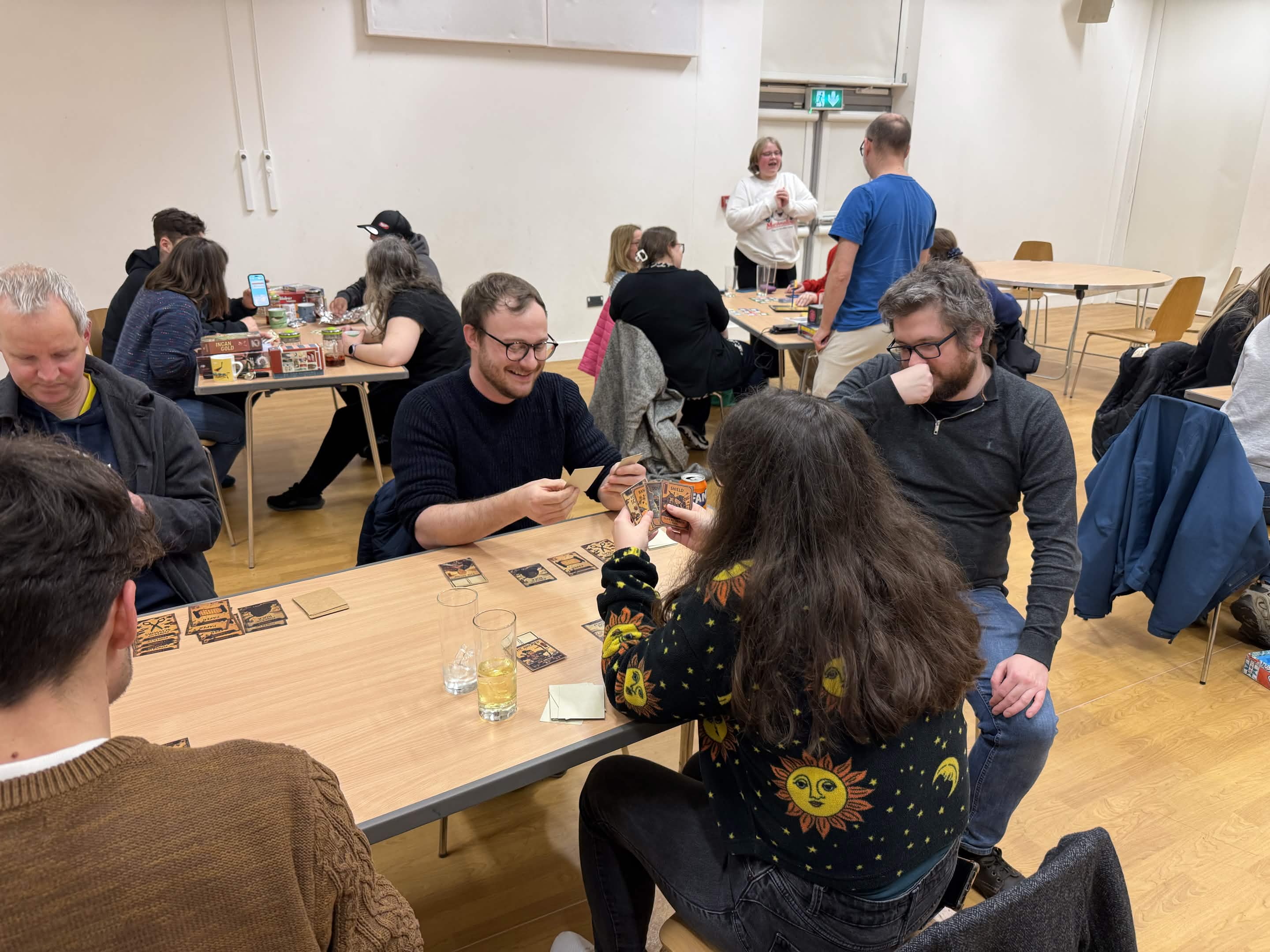 People playing Shadow Hands at a board game night
